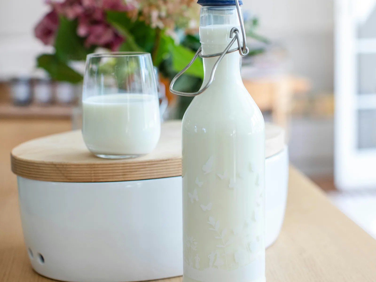 Glass of milk and a milk bottle on a table