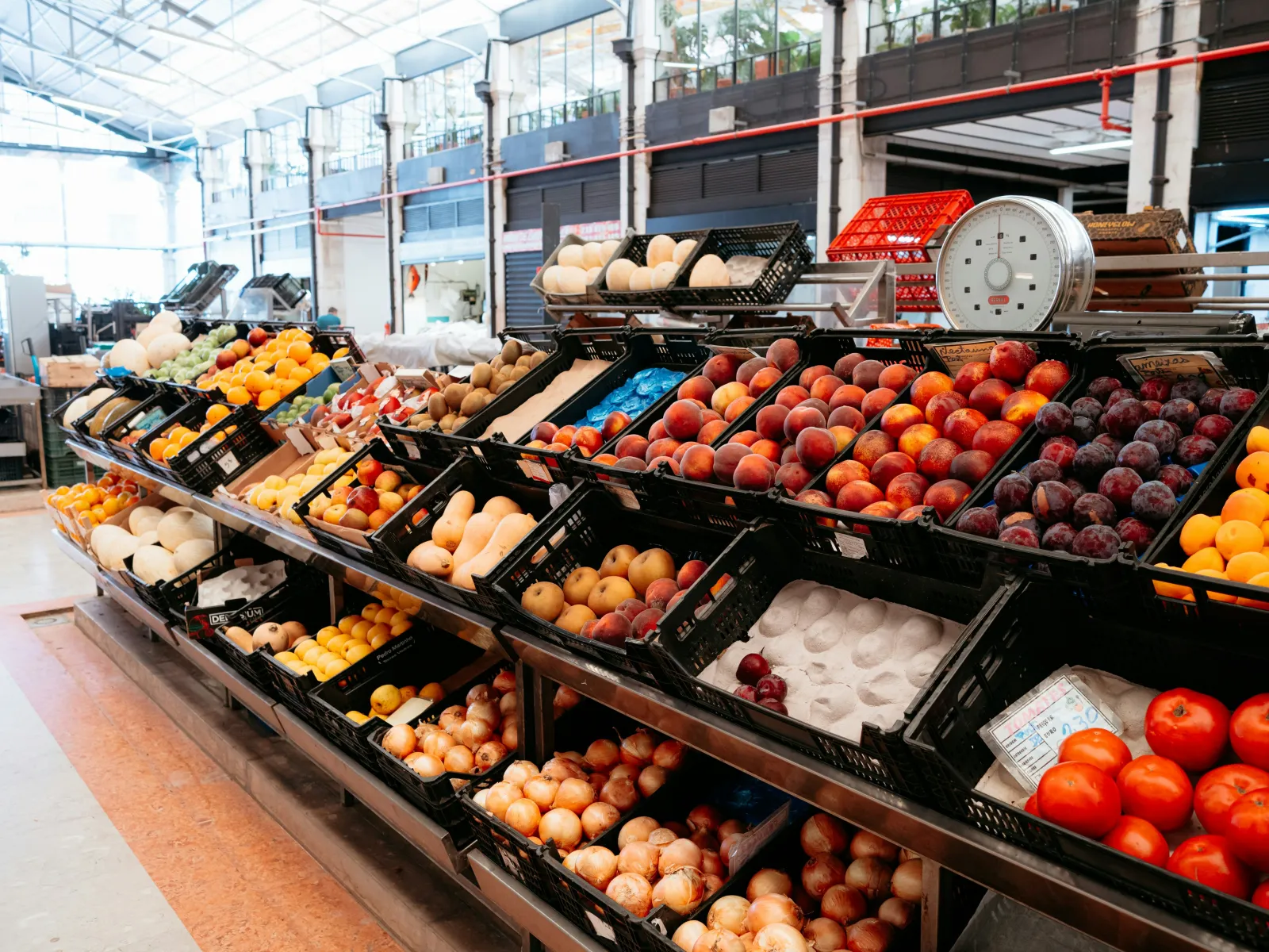 Crates of fresh fruit and vegetables in a produce hall